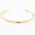 Gold stainless steel open cuff bracelet with inspire engraving in minimalist style - inspire