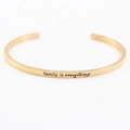 Golden stainless steel mantra bracelet featuring engraved family is everything text - family is everything