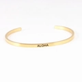 Detailed macro view of the gold-plated Mantra Bracelet with engraved ALOHA lettering - ALOHA