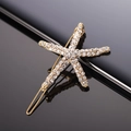 Chic gold starfish hair clip with sparkling crystals on a sleek black background - Gold Starfish Full Rhinestone Frog Clip