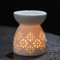 White ceramic essential oil burner with floral cutouts and warm glowing light effect - Small Flowers / Aromatherapy Burner + Candle Tray