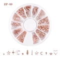 Macro view of rose gold moon star nail charms in a 12-compartment storage case - Rose Gold Star Moon Feather Combination(ZP-09)