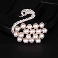 Detailed view of elegant rose gold swan brooch with white pearls and sparkling crystals - 254-1 Swan