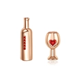 Detailed macro of asymmetric rose gold wine bottle and cup stud earrings with red zircons - Rose Gold