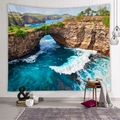 Detail of bohemian ocean landscape tapestry on a white brick wall in a cozy room setting - Blue Sea View