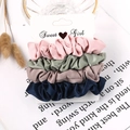 Detailed view of four satin silk scrunchies in pastel colors on a Sweet Girl card - Velvet Pink Blue Grey Black 4-Pack
