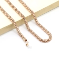 Detail of rose gold metal eyewear chain with anti-slip silicone loops and corn link texture - Gold