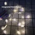 Macro detail of LED snowflake string lights with clear battery box and cold white glow - 1m 10-LED (2AA Battery Model) / Integrated Snowflake