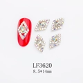 Macro detail of red rhombus crystal rhinestones and silver alloy nail art charms - Silver Base Hollow Aurora Diamond (LF3620)