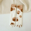 Close-up of plush coral fleece cat claw socks in cream white with soft brown patterns - One Size / Spotted Khaki