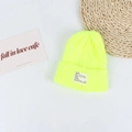 Close-up of neon yellow ribbed knit beanie with stylish white lettered woven label - Head Circumference 50-58cm / Neon Yellow