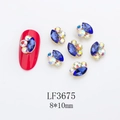 Macro detail of 8x10mm marquise crystal nail charms with metal setting and rhinestones - Gold Base Royal Blue with AB (LF3675)
