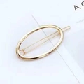 Minimalist gold oval hollow metal hair clip with a sleek geometric snap-on design - Ellipse