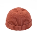 Detail of rust red knit docker hat showing thick ribbed texture and neat top stitching - Caramel color