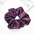 Close-up of deep purple satin scrunchie showing smooth silk-like texture and glossy finish - Purple