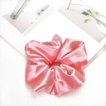 Pink satin scrunchie with glossy finish shown on minimalist magazine background - Rose Pink