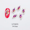 Macro shot of 8x16mm silver horse-eye alloy nail charms with purple rhinestones - Violet (LF3655)