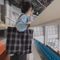Grand sac cabas à carreaux avec anses en cuir noir porté à l'épaule dans un stade - Carreaux Bleu Marine Horizontal