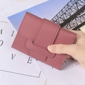 Pink PU leather short tri-fold wallet for women being held in hand for size display - Deep Pink