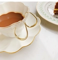 Detailed view of irregular gold hoop earrings resting on a white ceramic coffee cup rim - 4# Gold Shiny Large Waterdrop Hoop (4# Ear Hook-Gold-Waterdrop)