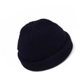 Detail view of navy knit docker cap with thick ribbed texture and rolled cuff edge - Adult / Navy Blue