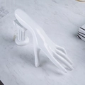 Polished white resin hand mold for jewelry display on marble surface backdrop - White