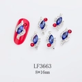 Macro detail of alloy nail jewelry with blue marquise stone and red accents, 8x16mm size - Royal Blue (LF3663)