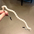 Handmade white pearl headband with elegant wave design and black anti-slip end caps - Wave Pearl Style