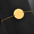 Detailed view of 20mm polished gold round pendant on fine stainless steel chain bracelet - Gold