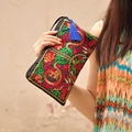 Ethnic black satin clutch with intricate dragon embroidery and blue tassel charm - Dragon Vein Agate Style