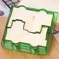 Close-up of green puppy-shaped sandwich cutter slicing white toast bread on a table - Small Car - Green