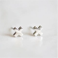 Minimalist silver cross stud earrings in brushed titanium steel on white marble - X Shape / Steel