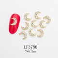 Detailed view of 7x8.5mm gold moon nail art charm with rhinestones and red nail sample - Gold White Rhinestone Crescent (LF3780)