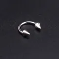Close-up of 1mm stainless steel horseshoe ring with 8mm inner diameter and cone tips - Circular Barbell/Spike/10mm
