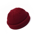 Detail of dark red ribbed knit texture on a brimless docker cap with cuffed edge - Adult / Burgundy