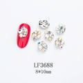 Detail view of 8x10mm marquise alloy nail charms with colorful rhinestones on red nails - Silver Base White Aurora with Pave (LF3688)