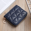 Detail of navy blue quilted PU leather mini wallet on a rustic wooden tabletop - Dark Blue