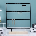 Detailed view of 3-tier black metal earring organizer with a natural pine wood base - 66 Holes / Black