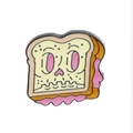 Detail view of cartoon toast-shaped enamel brooch with a skull face design and pink bow - Toast Skeleton Style (C1475-1)