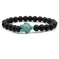 Close-up of black matte beads and green turquoise turtle charm on a stretch bracelet - Green Turtle Matte Black