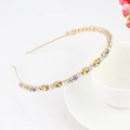 Golden slim headband with colorful rhinestones displayed on a white ceramic cup - Style 09-Gold