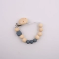 Detailed view of silicone and wooden pacifier clip with grey beads and geometric accents - Gray