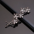 Close-up of four crystal-embedded flower hair clips with vintage silver metal finish - Black Five Flower