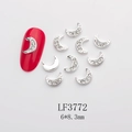 Detailed view of silver moon nail charms with rhinestones sized 6x8.3mm on red nails - Silver Hollow White Rhinestone Moon (LF3772)