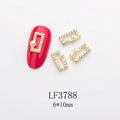 Detailed view of 6x10mm gold nail charms with AB rhinestones and pearls on red nails - Gold Aurora Pearl Frame (LF3788)