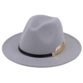 Detailed close-up of a grey wool fedora featuring a gold metal leaf and black band - Gray