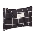 Detail of checkered canvas makeup bag featuring a natural style handmade woven label - Black Grid / Large