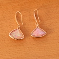 Macro shot of fan-shaped pink gemstone drop earrings with gold hooks on wood texture - Fan Pink