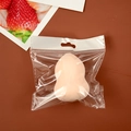 Flesh-colored makeup sponge puff in transparent packaging on a wooden table surface - Gourd Shape (Individual Bag) / Nude