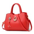 Red lychee texture leather tote bag with gold metal twist lock and tassel detail - Red
